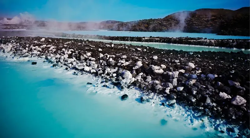 Iceland geothermal lagoon and spa — steaming blue water among volcanic rock